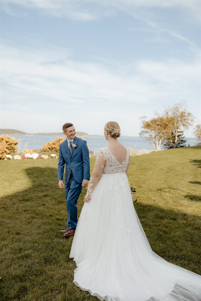 Groom turning around to see bride in wedding attire for first look